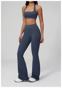 Detail of high waisted flare yoga pants with square neck halter sports bra in dusty blue