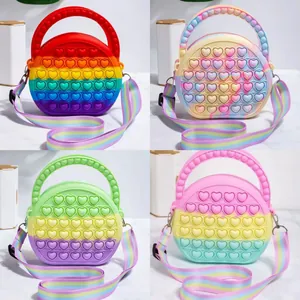 Silicone heart-shaped pop-it shoulder bag with adjustable rainbow strap for kids