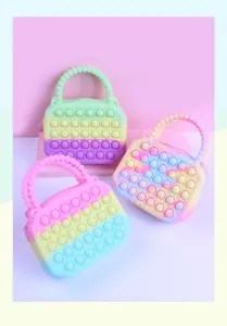 Detail of three colorful silicone pop-it purses showing bubble textures and bead handles