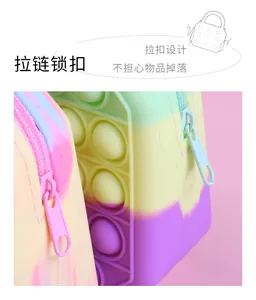 Macro view of rainbow pop-it bag featuring a secure zipper lock to prevent item loss