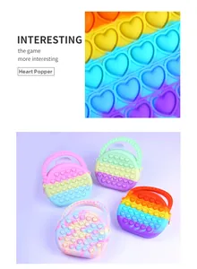 Detailed view of heart-shaped pop-it silicone bags in macaron and rainbow gradients