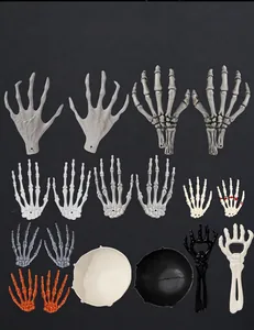 Collection of realistic plastic Halloween skeleton hands and skulls for decor