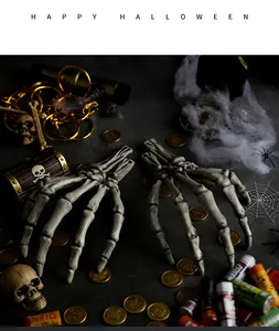 Close-up of realistic Halloween skeleton hands with vintage bone texture on stone