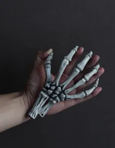 Detailed view of realistic skeleton hand prop with distressed texture for Halloween decor