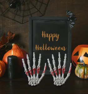Detail of realistic skeleton hands with fake blood splatter for Halloween decorations