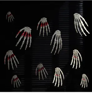 Detail of realistic Halloween skeleton hands with blood stains and hanging holes decoration