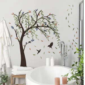 Detail of hand-painted large tree wall sticker with multicolored leaves and flying birds