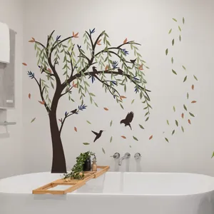 Detail of hand-painted large tree wall sticker with flying birds above a bathtub