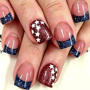 Short square press-on nails featuring red star patterns and blue glitter french tips