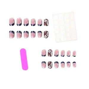 24-piece set of short square press-on nails with blue French tips and star glitter design