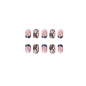 Detail of short square press-on nails with blue French glitter and star patterns