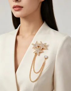 Detail of a sparkling gold star brooch with rhinestone chains on a blazer lapel