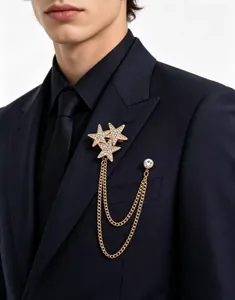 Detail of gold star chain brooch with rhinestones pinned on a dark blue suit lapel