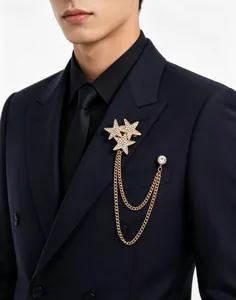 Detail view of sparkling star brooch with gold chains on a navy suit lapel