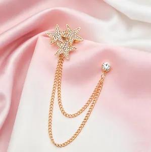 Elegant gold star tassel brooch with sparkling rhinestones and delicate chains
