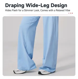 Close-up of light blue high-waisted wide-leg sports pants with elegant drape fabric