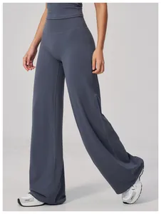 Detail view of high-waist wide-leg sports pants in dark grey-blue elastic fabric