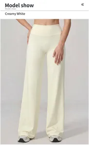 Detail of high waisted wide leg creamy white sports trousers with flowy fabric