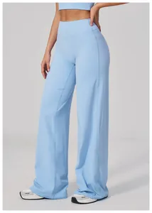 Detail showing high-waist yoga pants with vertical stitching and light blue fabric