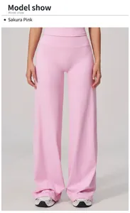 Detail of high waisted wide leg yoga pants in cherry blossom pink with soft fabric drape