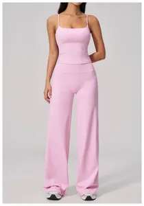 Pink high-waisted wide-leg yoga trousers and camisole top set in matte athletic fabric