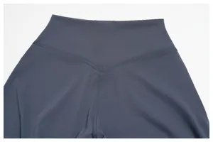 Detail of high-waisted workout leggings featuring V-shape back stitching in dark grey