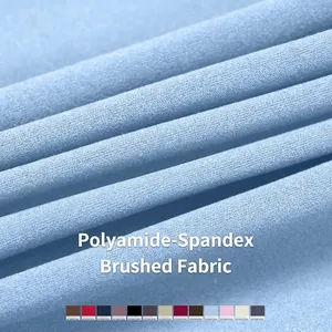 Close-up of light blue brushed fabric sports trousers with four-way stretch texture