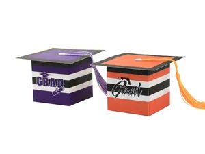 Detail of striped graduation cap gift boxes with tassels and grad lettering