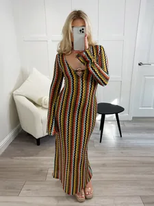 Detail view of colorful zigzag pattern knit dress with deep V-neck and metal ring detail