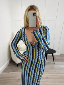 Close-up of deep V-neck dress with metal ring detail and chevron zigzag patterns