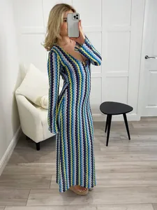 Detail view of colorful zigzag knit pattern on a slim-fit V-neck long-sleeve maxi dress