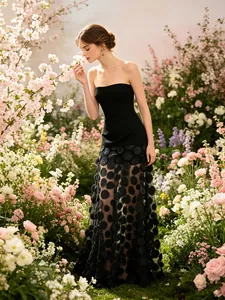 Elegant strapless black tube gown with large polka dot tulle skirt in cherry garden