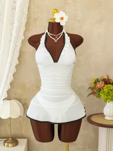 White one-piece swimsuit with black trim, ruffled V-neckline, and ruched belly control