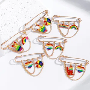 Detailed macro view of gold enamel rainbow pride pins with Love Wins lettering