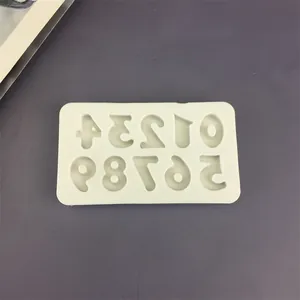 Top view of white silicone mold featuring numbers zero to nine for cake decoration