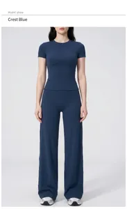 Close-up of slim-fit short sleeve top and high waist wide leg pants in Badge Blue