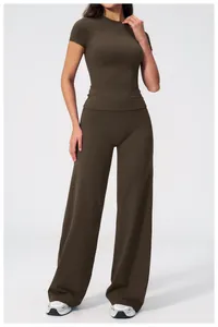 Detail of high-waist wide-leg pants and slim fit short sleeve top in dark brown