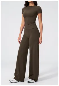Detail view of high-waist wide-leg fitness pants and compression shirt in dark coffee