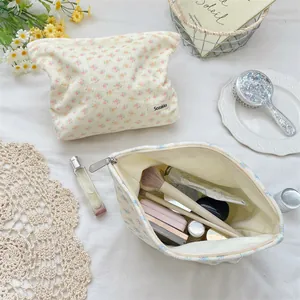 Floral corduroy cosmetic bag detail showing spacious interior and metal zipper