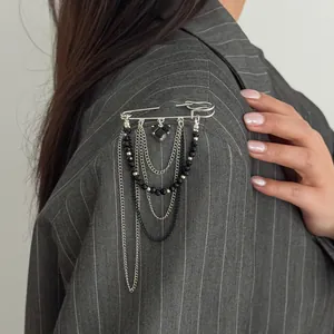 Gothic silver safety pin brooch with black heart pendant and tiered metallic chain fringe