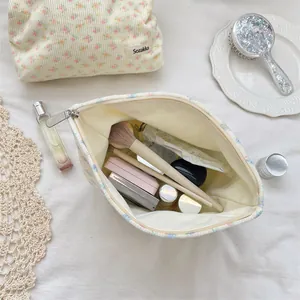 Close-up of floral quilted cotton makeup bag with metal zipper and interior storage