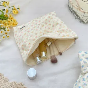 Detail of floral corduroy makeup bag interior showing storage space for beauty products