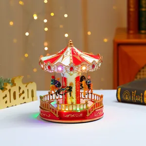 Close-up of a musical carousel box with red and white roof and warm LED lighting