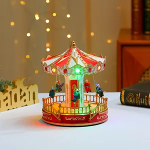 Detail of illuminated carousel music box with red and gold motifs and LED lights