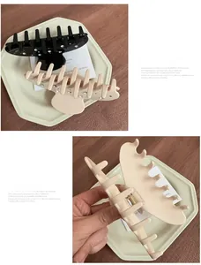Detail view of black and beige acetate hair claws with sparkling rhinestones set
