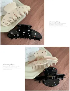 Detail of large acetate hair claws in beige and black with sparkling colorful rhinestones