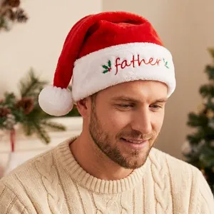 Detail of plush Christmas hat with red Father embroidery and holly leaf on white brim