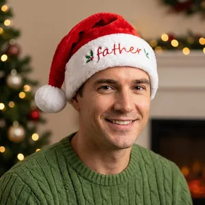 Close-up of plush Christmas hat with red father embroidery and holly leaf details