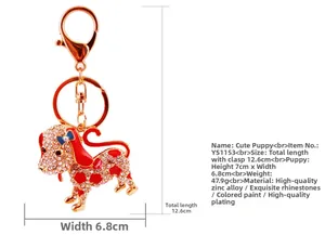 Macro shot of sparkling crystal dog keychain with red enamel and golden lobster clasp