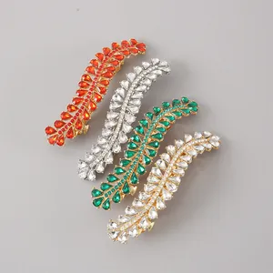 Detailed macro view of four alloy hair clips with colorful leaf-shaped rhinestones